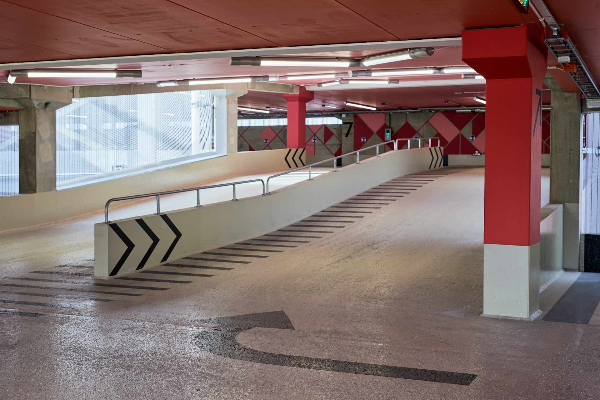 Parkeringshuset vid Mörby Centrum: interiör ramp med markeringar och belysning i parkeringshuset. Byggprojektlett av In3prenör. Foto Martin Ekwall.