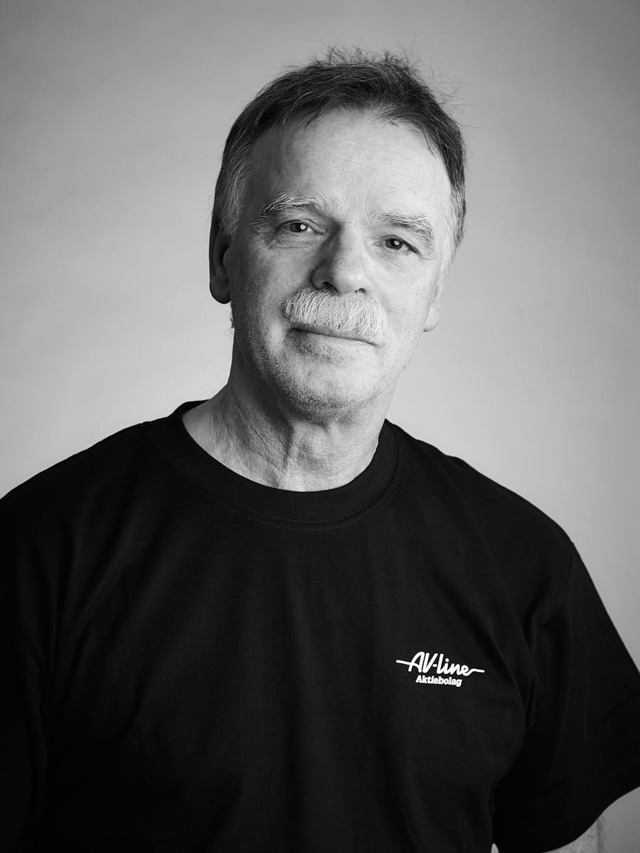 AV-Line porträtt av medarbetare i svart t-shirt mot grå bakgrund