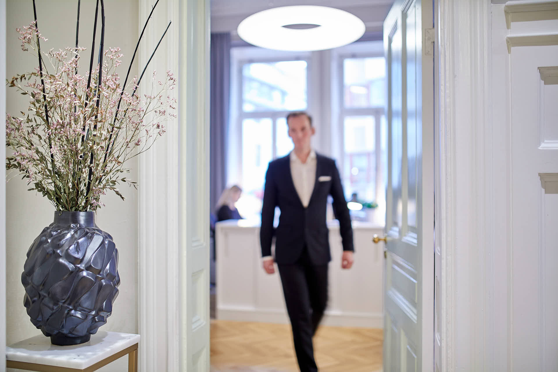 Investeringsbolag, en man i kostym går från ljus reception till en hall i Östermalm, Stockholm. Foto Martin Ekwall.